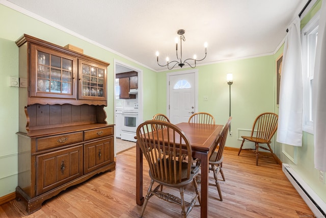 dining room with a chandelier, baseboards, baseboard heating, light wood-type flooring, and crown molding