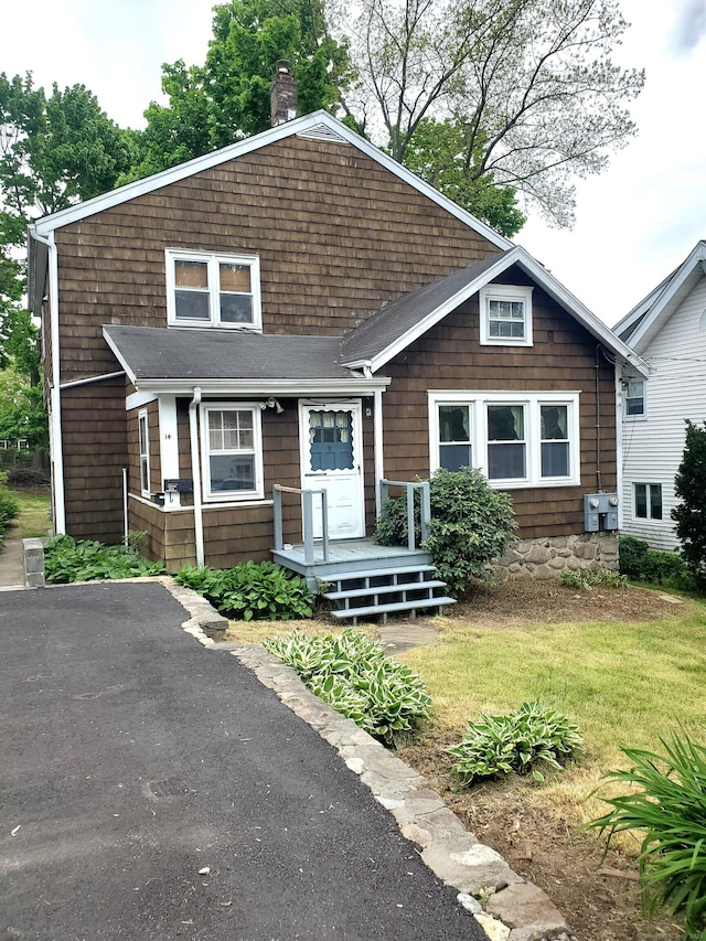 view of front facade with a front lawn and a chimney