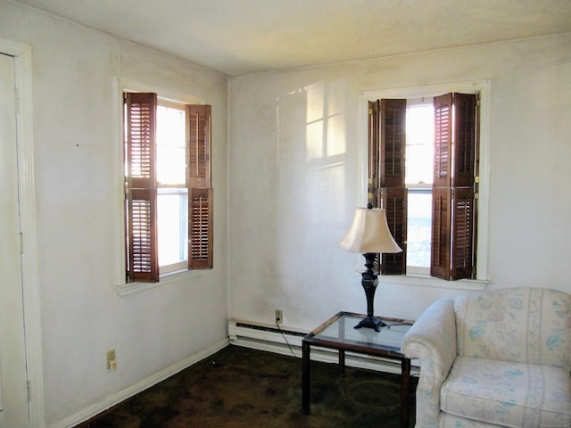 14 Sycamore St, Norwalk, CT 06855 - living area featuring plenty of natural light, dark carpet, baseboards, and baseboard heating