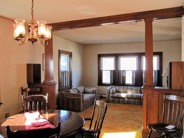 carpeted dining space with decorative columns, beam ceiling, and a notable chandelier