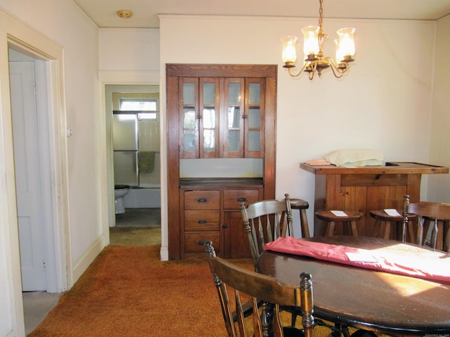 carpeted dining space featuring a notable chandelier