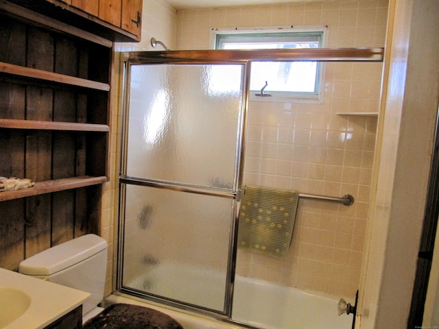 full bath with shower / bath combination with glass door, vanity, and toilet