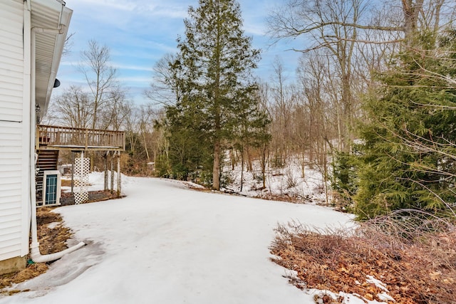 yard covered in snow with a wooden deck