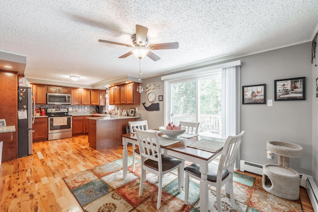 dining space with a ceiling fan, light wood-type flooring, crown molding, and baseboard heating