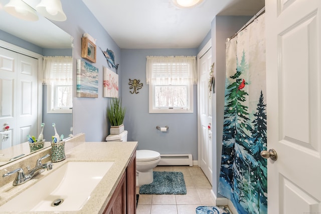 bathroom featuring toilet, tile patterned flooring, a baseboard heating unit, and a wealth of natural light