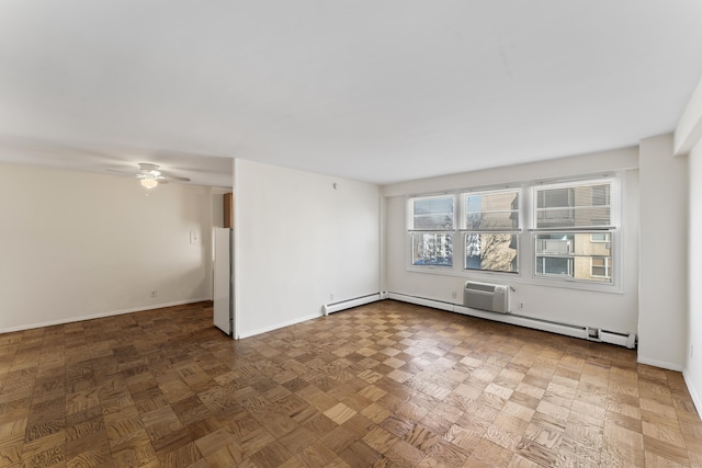 empty room featuring baseboards, baseboard heating, and a ceiling fan