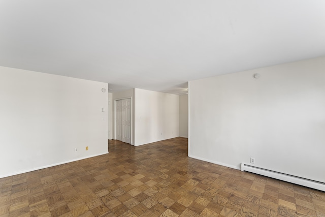 spare room featuring baseboards and baseboard heating