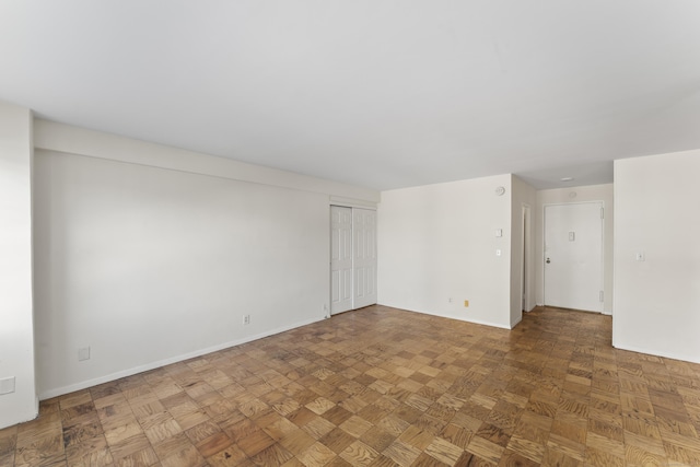 unfurnished room featuring baseboards