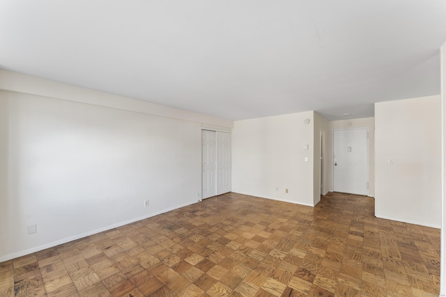 spare room featuring baseboards