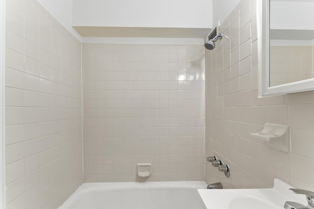 full bathroom with washtub / shower combination and a sink