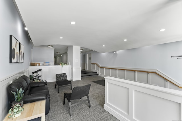 living area with recessed lighting, a wainscoted wall, carpet flooring, and a decorative wall