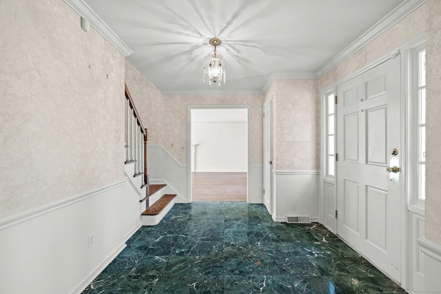 foyer entrance with visible vents, wallpapered walls, stairs, wainscoting, and crown molding