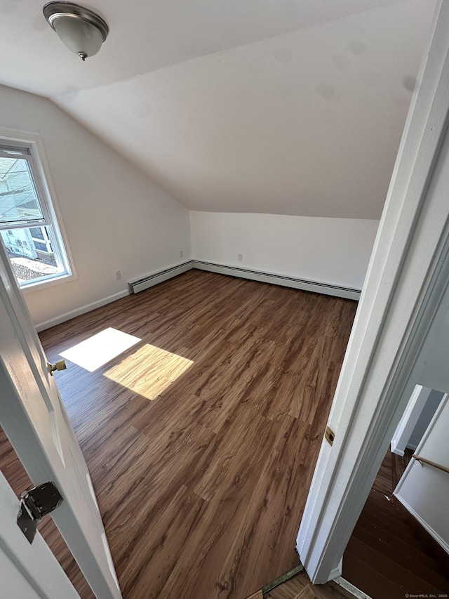 bonus room featuring baseboards, wood finished floors, and vaulted ceiling