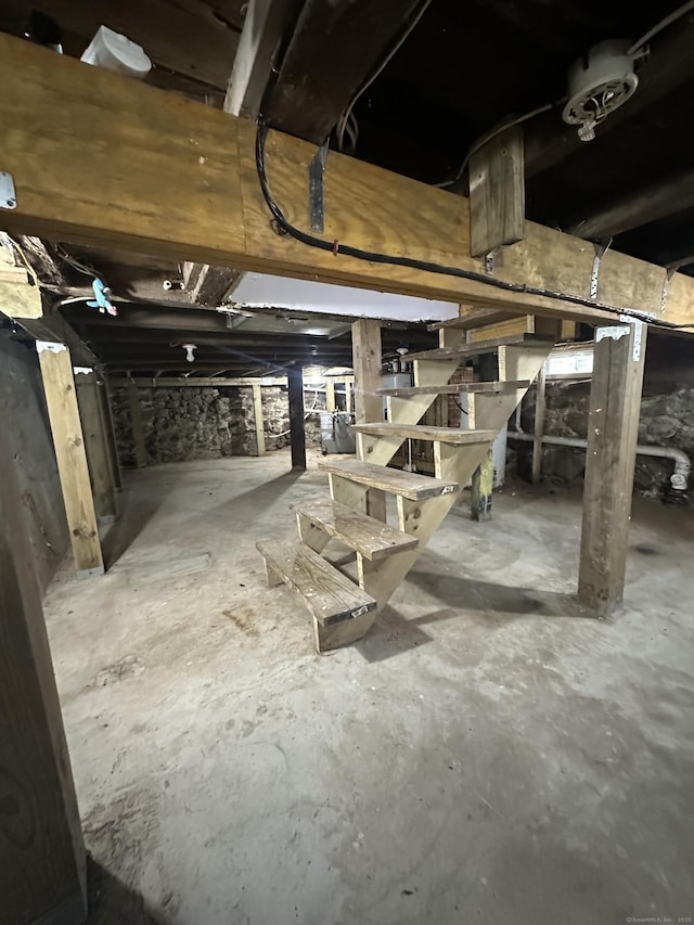unfinished below grade area featuring stairs