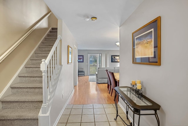 stairs featuring tile patterned flooring and baseboards