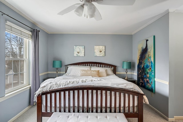 carpeted bedroom featuring ornamental molding, a ceiling fan, and baseboards