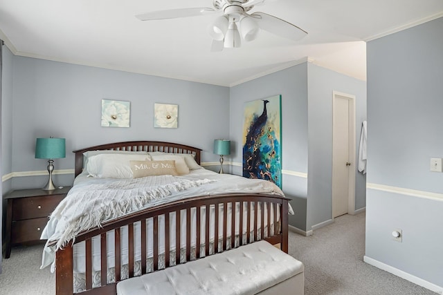 carpeted bedroom with baseboards, a ceiling fan, and crown molding