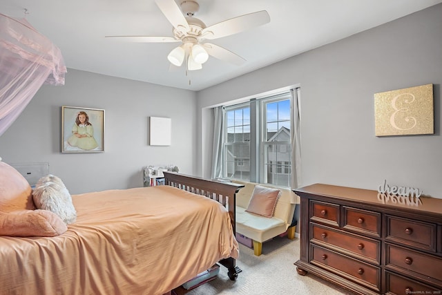 bedroom featuring light carpet and a ceiling fan