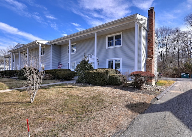 view of front of property with a front lawn and a chimney