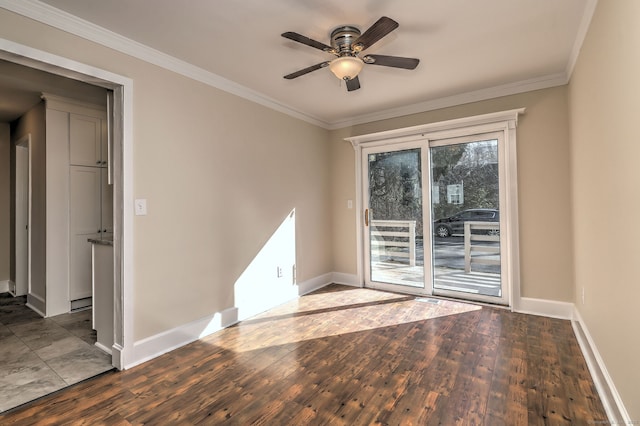 spare room with hardwood / wood-style floors, crown molding, and baseboards