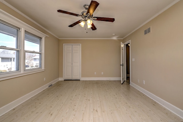 unfurnished bedroom with baseboards, visible vents, and ornamental molding