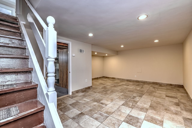 finished below grade area featuring visible vents, recessed lighting, stairway, and baseboards