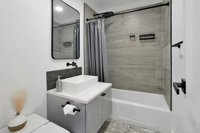 bathroom featuring decorative backsplash, vanity, toilet, and shower / tub combo with curtain