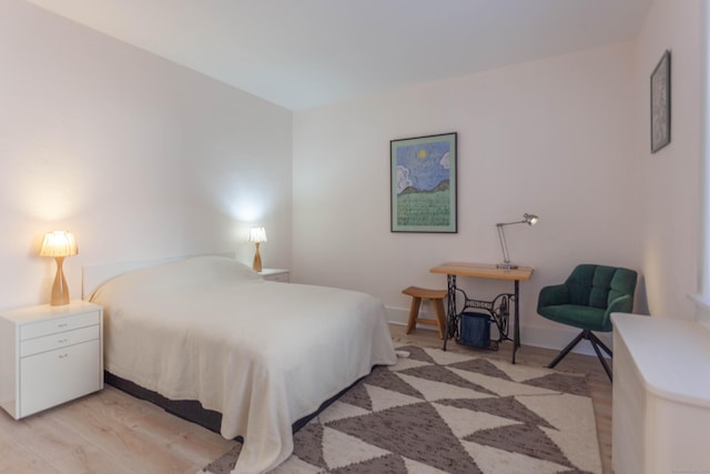 bedroom featuring light wood-type flooring and baseboards