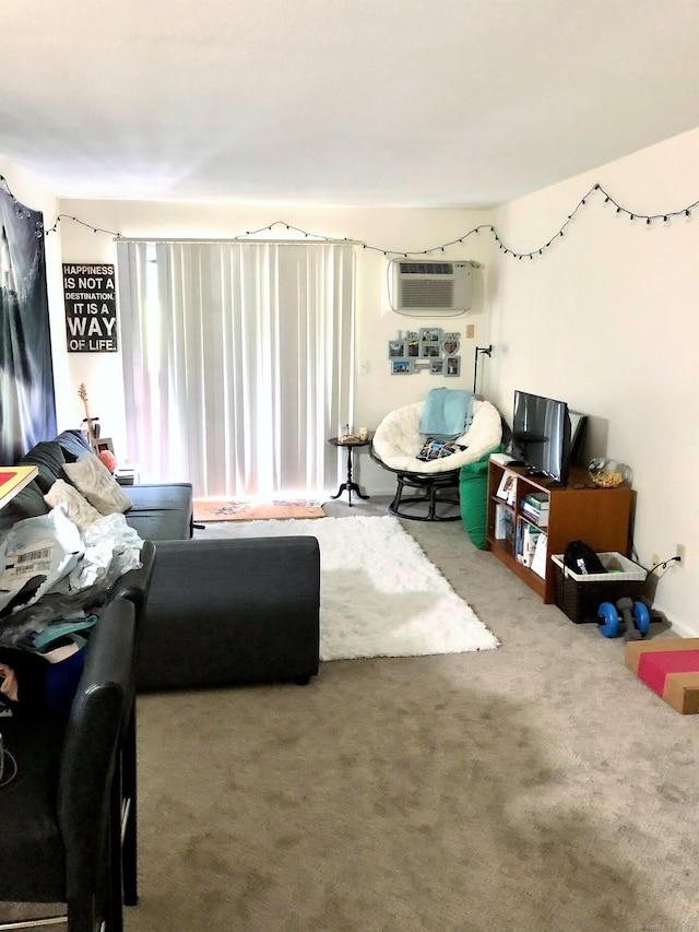 carpeted living room featuring a wall unit AC