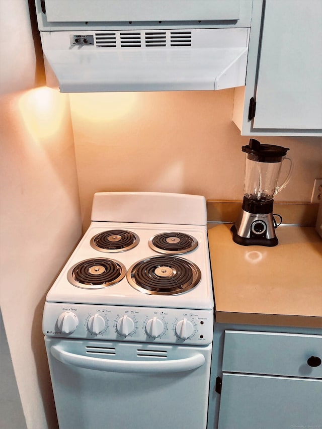 kitchen with electric range and range hood