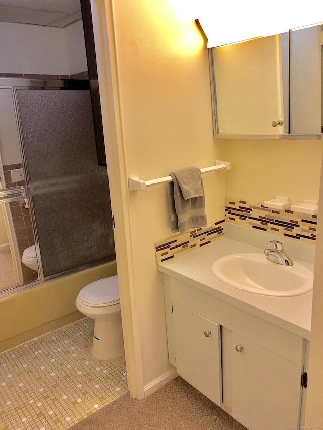 full bathroom featuring decorative backsplash, toilet, enclosed tub / shower combo, tile patterned flooring, and vanity