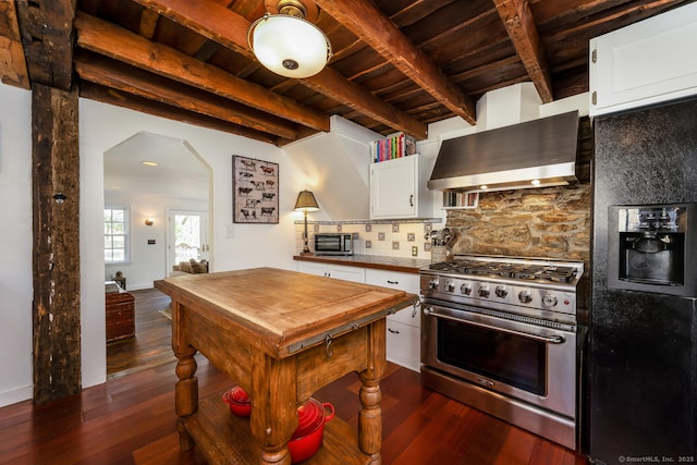 175 Mountain Rd, Wilton, CT 06897 - kitchen with stainless steel appliances, wall chimney exhaust hood, a wood ceiling with exposed beams, dark wood finished floors, and arched walkways
