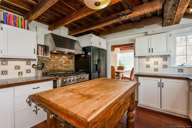 175 Mountain Rd, Wilton, CT 06897 - kitchen featuring wall chimney exhaust hood, a wood ceiling with exposed beams, range, black refrigerator with ice dispenser, and dark wood-type flooring