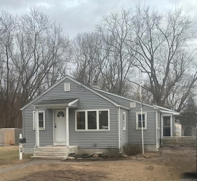 view of front of house featuring a chimney