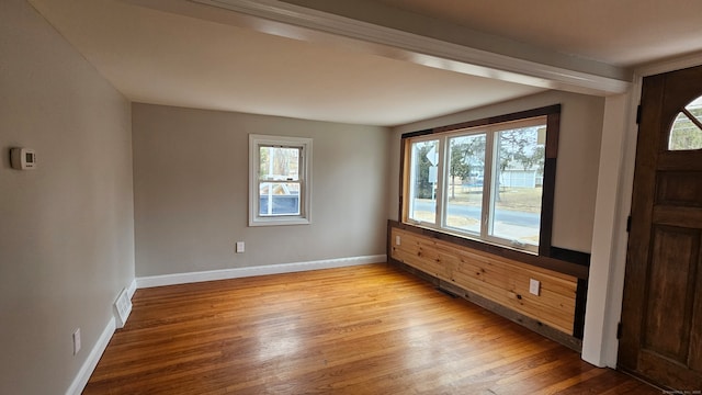 unfurnished room with light wood-type flooring, baseboards, and visible vents