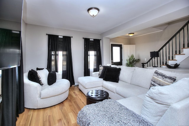 living room with stairway and wood finished floors