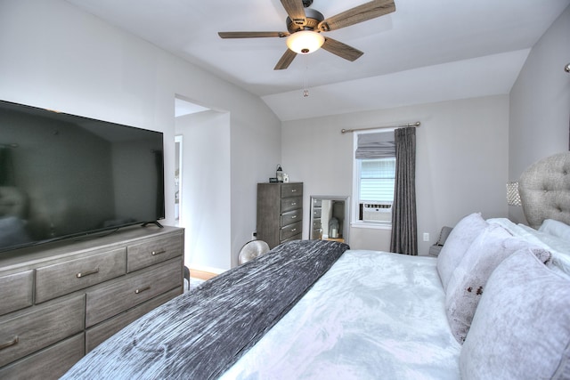 bedroom featuring cooling unit, vaulted ceiling, and a ceiling fan