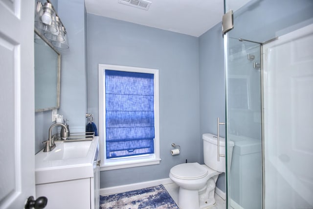 bathroom with visible vents, toilet, vanity, baseboards, and walk in shower