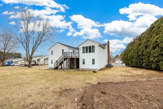 rear view of house with a wooden deck, a chimney, stairs, a yard, and central air condition unit