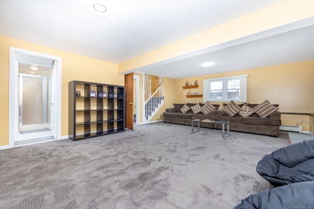 living room featuring a baseboard heating unit, carpet floors, stairway, and baseboards