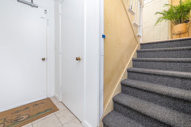 staircase featuring tile patterned flooring