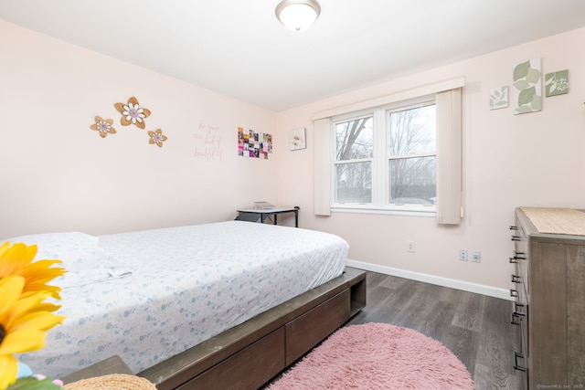 bedroom featuring dark wood-style flooring and baseboards