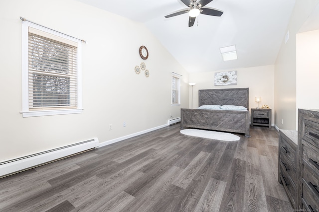 unfurnished bedroom featuring vaulted ceiling, baseboard heating, wood finished floors, and baseboards