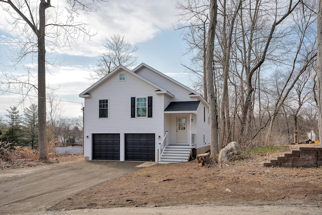 split level home featuring driveway, an attached garage, and a shingled roof