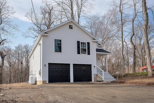 view of property exterior with a garage and driveway