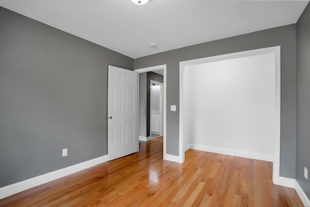 unfurnished bedroom featuring baseboards and light wood-style floors