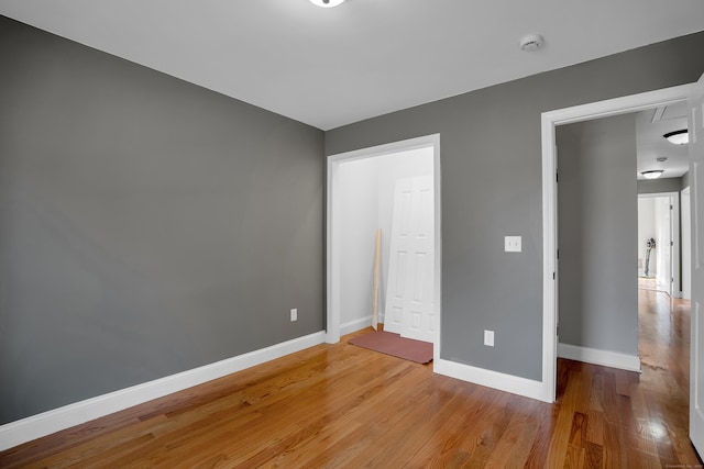 unfurnished bedroom featuring light wood-style flooring and baseboards