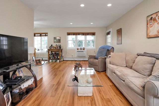 living room featuring a baseboard radiator, a wall mounted air conditioner, wood finished floors, and recessed lighting