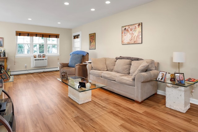 living area with recessed lighting, light wood-style flooring, baseboard heating, a wall mounted air conditioner, and baseboards