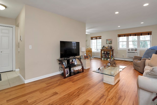 living area featuring light wood finished floors, a baseboard radiator, baseboards, and recessed lighting